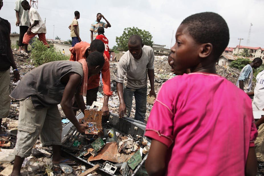 Young waste pickers sorting through trash in a dumpsite.