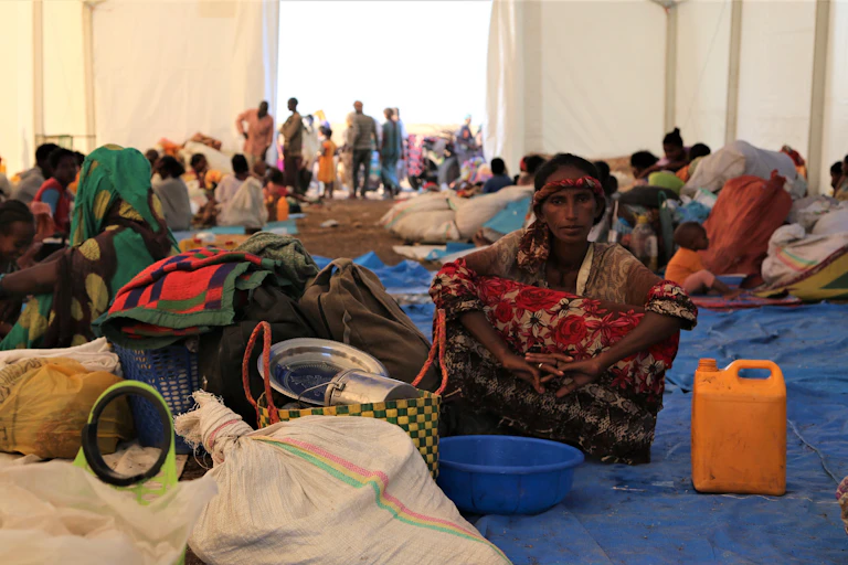Ethiopian woman sitting in a Sudanese refugee camp, November 2020.