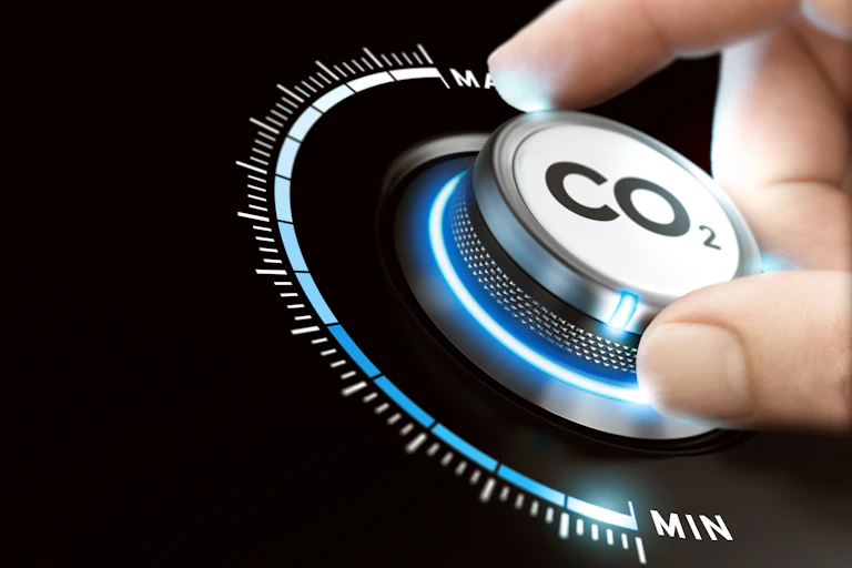 A hand adjusts a circular dial reading 'CO2'