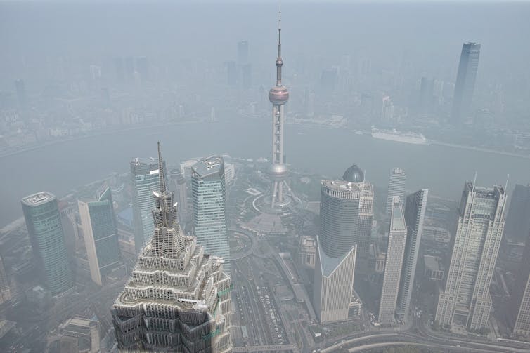 Skyscrapers viewed from above through smog.