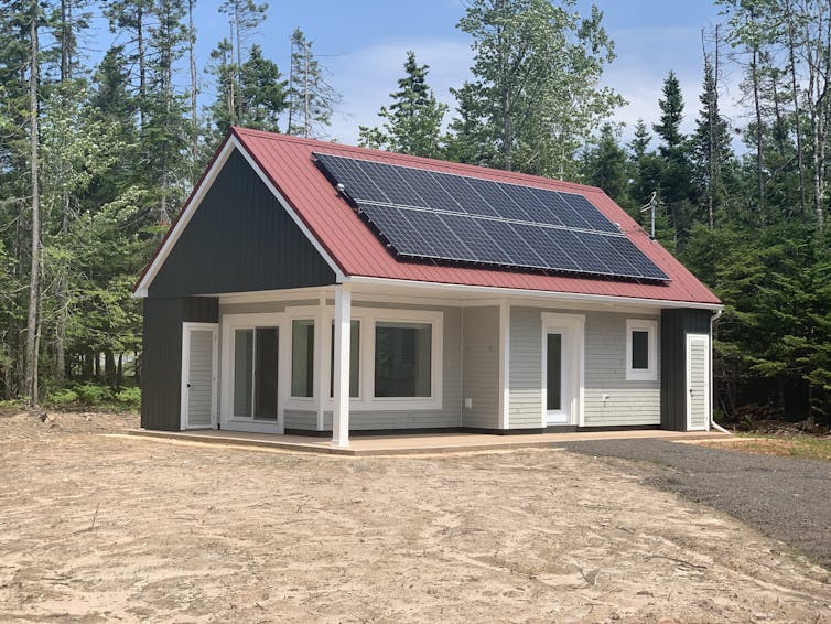 A newly constructed passive home with solar panels on the roof