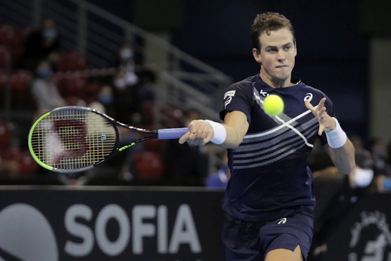 Vasek Poposil returns an opponent's shot