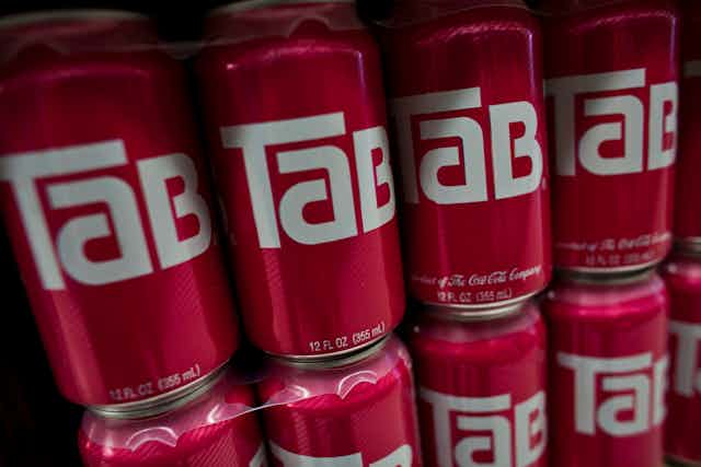 A row of red Tab cans.