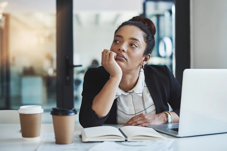 Woman looking bored at her computer