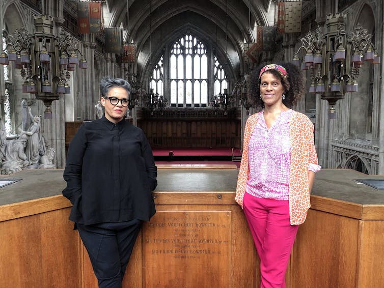 Writers Bernadine Evaristo adn Kit De Waal stand in a church.
