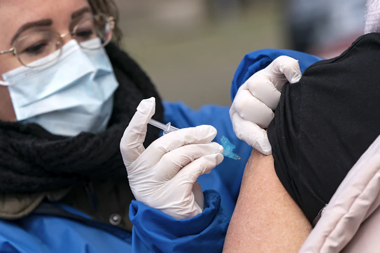 A medic vaccinating a patient.