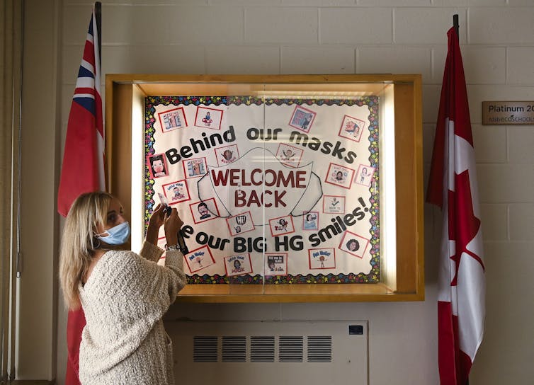 A teacher works on a display.