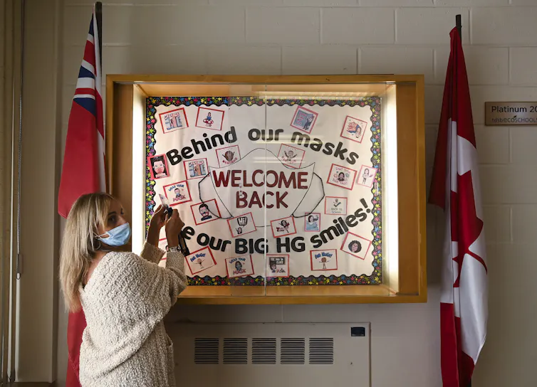 A teacher works on a display.