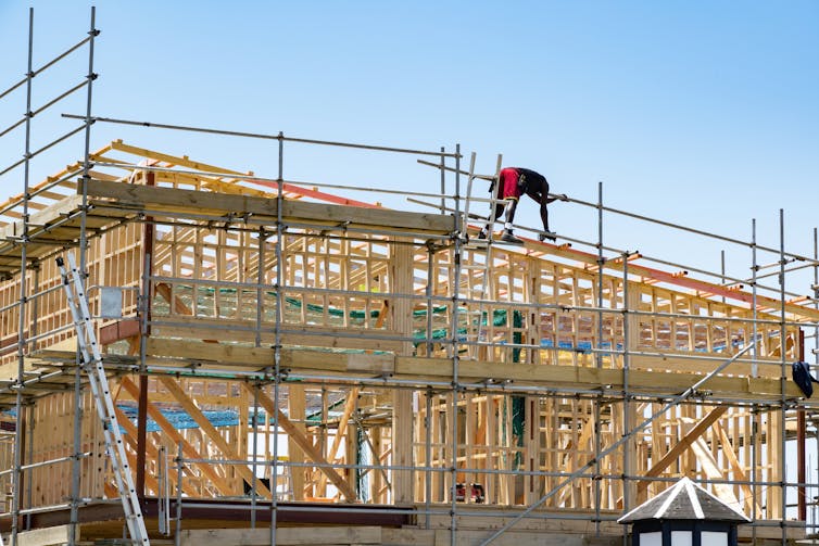 A new wooden frame house under construction.