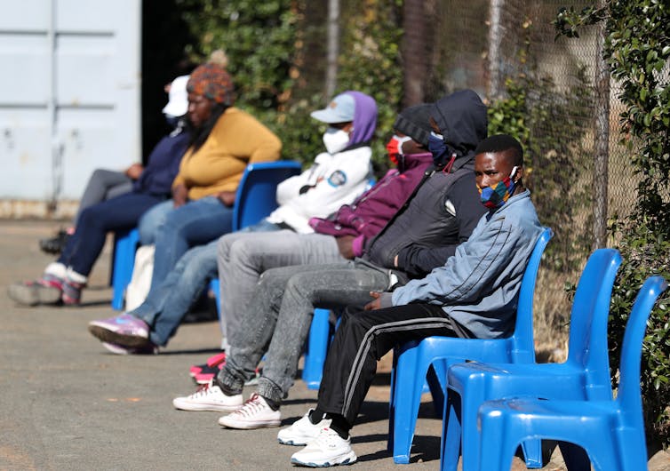 Volunteers in South Africa queuing to receive the Oxford vaccine.