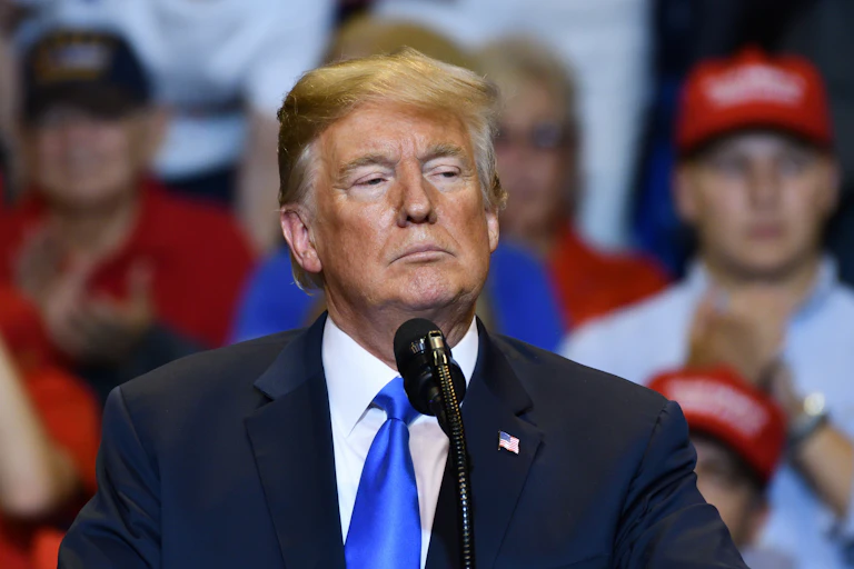 Donald Trump with a serious look as he delivers a speech.