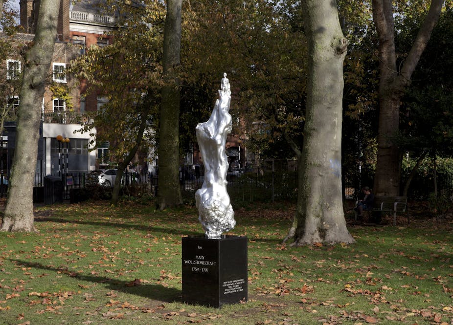 Silver statue in park.