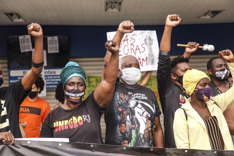 Line of Black Brazilians with their fists raised