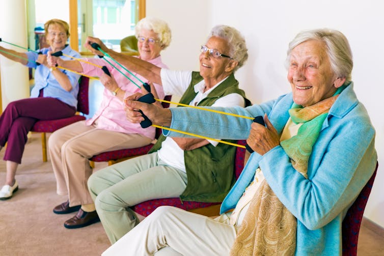 Aged care residents smiling as they exercise