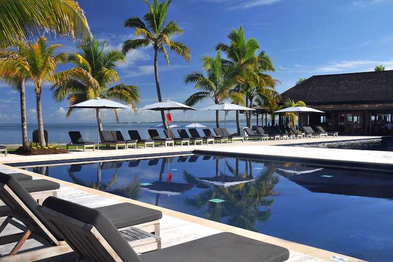 empty resort swimming pool and palm trees