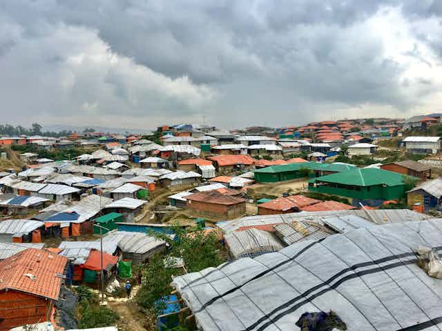 View of many makeshift coloured buildings under grey sky.