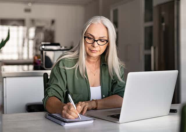 write an abstract on coronavirus A woman studying using a laptop and taking notes