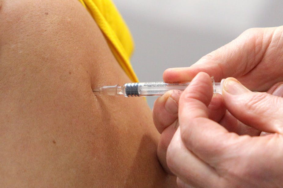 Close up of an arm being injected with a vaccine.
