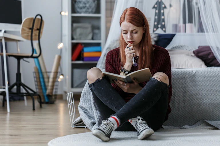 Girl in bedroom writing diary