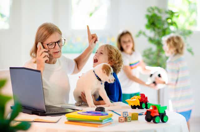 Mum working from home while kids demand attention