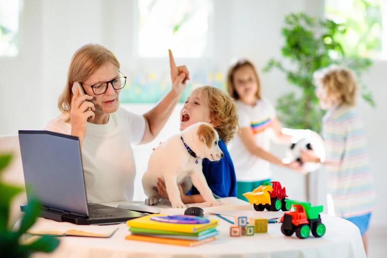 Mum working from home while kids demand attention