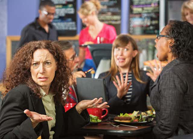 Image of people arguing over lunch.