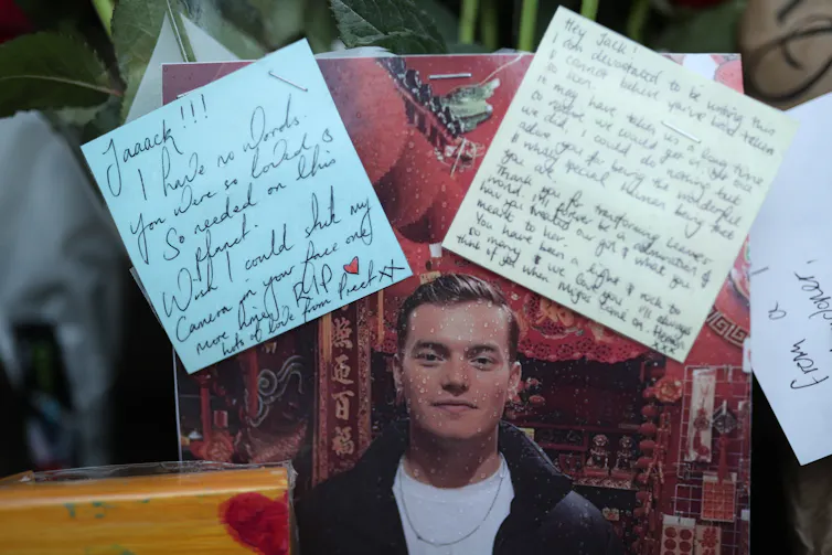 A photo of London Bridge victim Jack Merritt surrounded by letters and flowers.