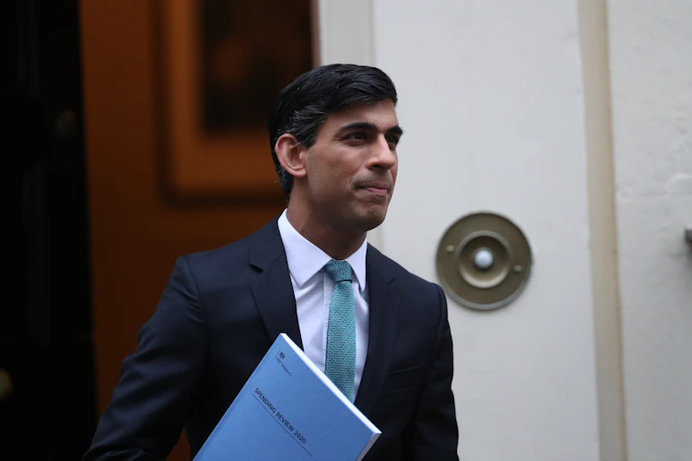 Rishi Sunak holding a copy of his 2020 spending review.