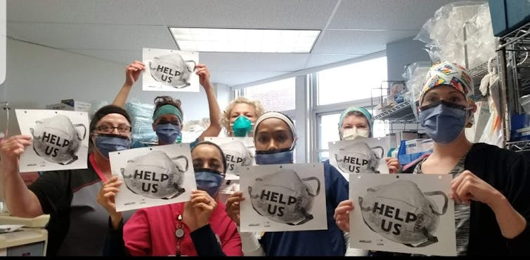 Women health-care workers in face masks holding up signs featuring N95 masks reading 'Help us'