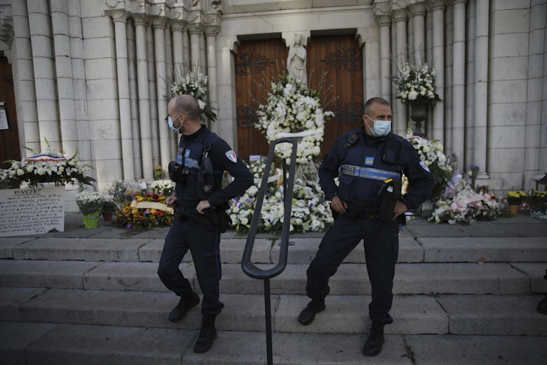 Policemen standing guard in front of a church.
