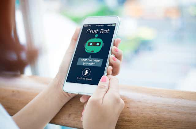 Person using chatbot on smartphone.