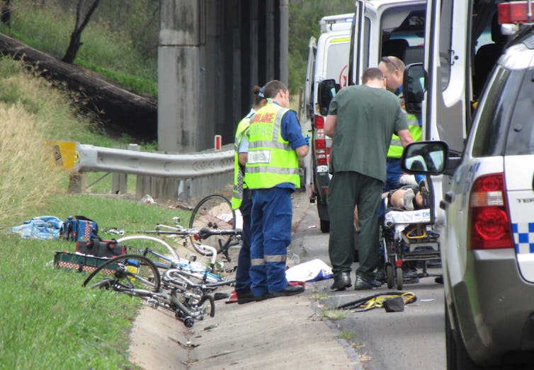 Police and ambulance attend an accident after a truck ran into cyclists