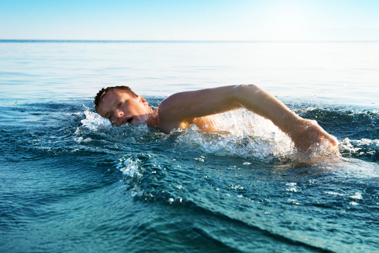 A young man swimming in the sea