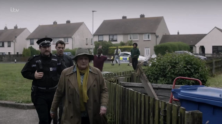 Police and detective Vera walk suburban streets