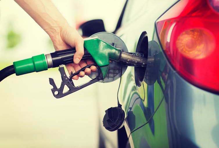 Filling car up with petrol at service station