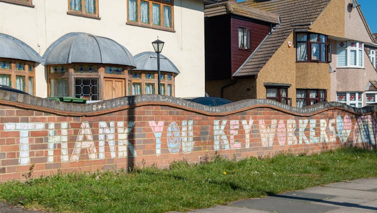 'Thank you keyworkers' written in large chalk letters on wall in front of houses.