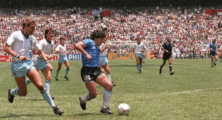 Footballers on a pitch.