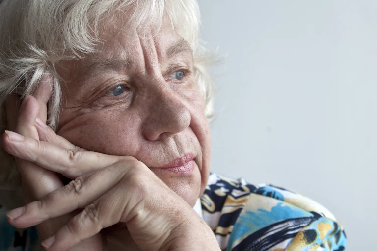 Older lady looking sad into distance
