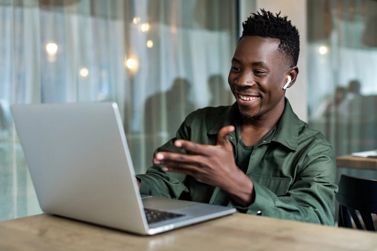 Young man chatting to his friends online