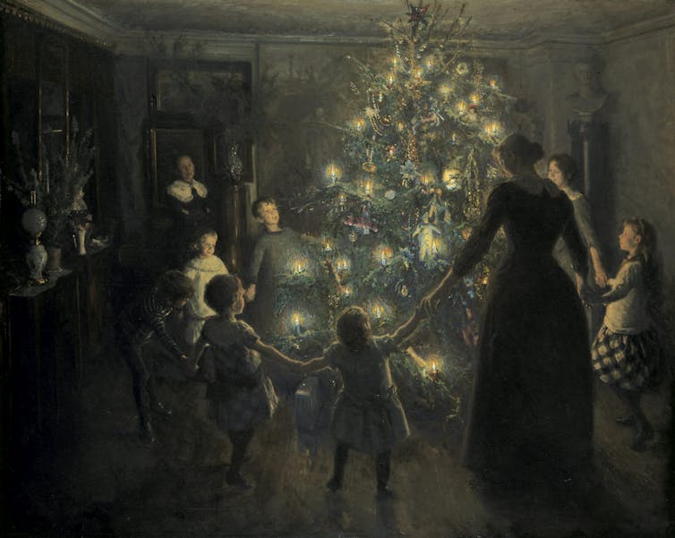 Painting of a family dancing around a Christmas tree.