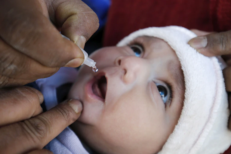 A baby being given an oral polio vaccination.