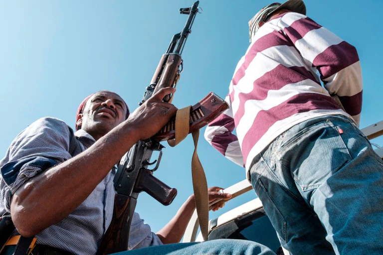 Amahara militia riding on the back of pick-up truck