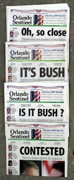A series of Florida newspapers with headlines saying it wasn't clear who won the 2000 election.