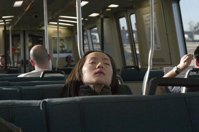 Woman sleeping on the bus.