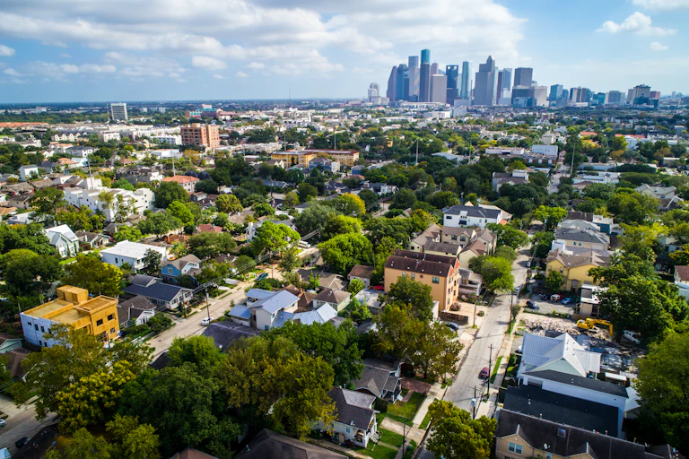 Aerial view of suburbs with city skyline in distance
