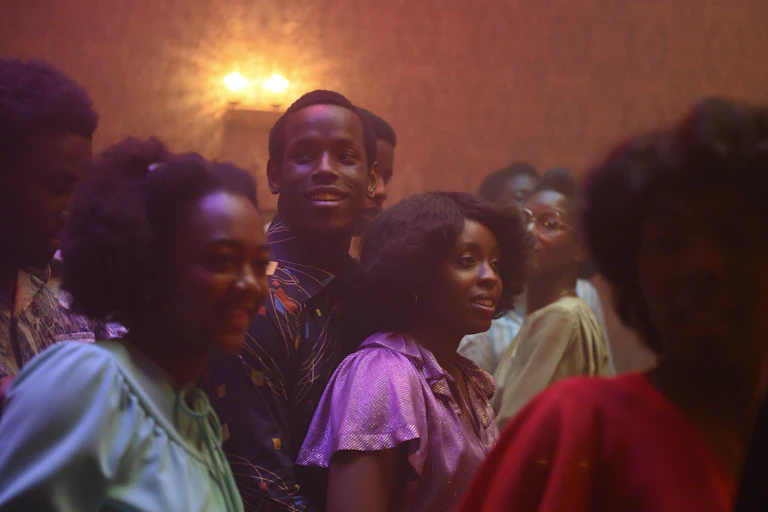 People dancing at a house party in the 70s.
