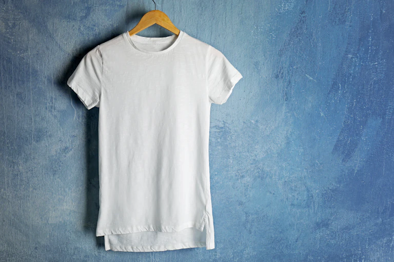 A white t-shirt on a hanger with a blue background.