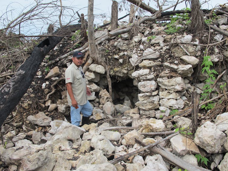 man beside a rocky mound