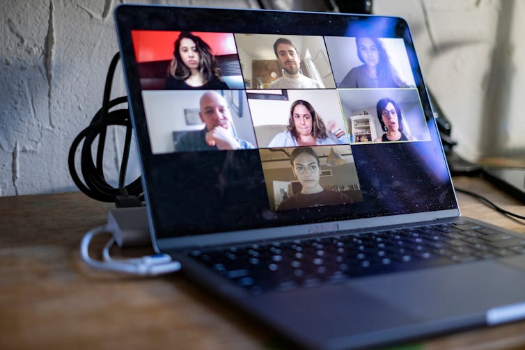 laptop screen showing seven people participating in an online meeting.