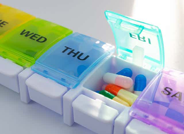 A weekly pill holder labelled with days of the week.